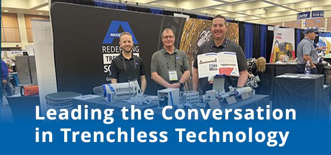 Akkerman team members at a trade show booth with trenchless equipment displays, representing No-Dig 2026.